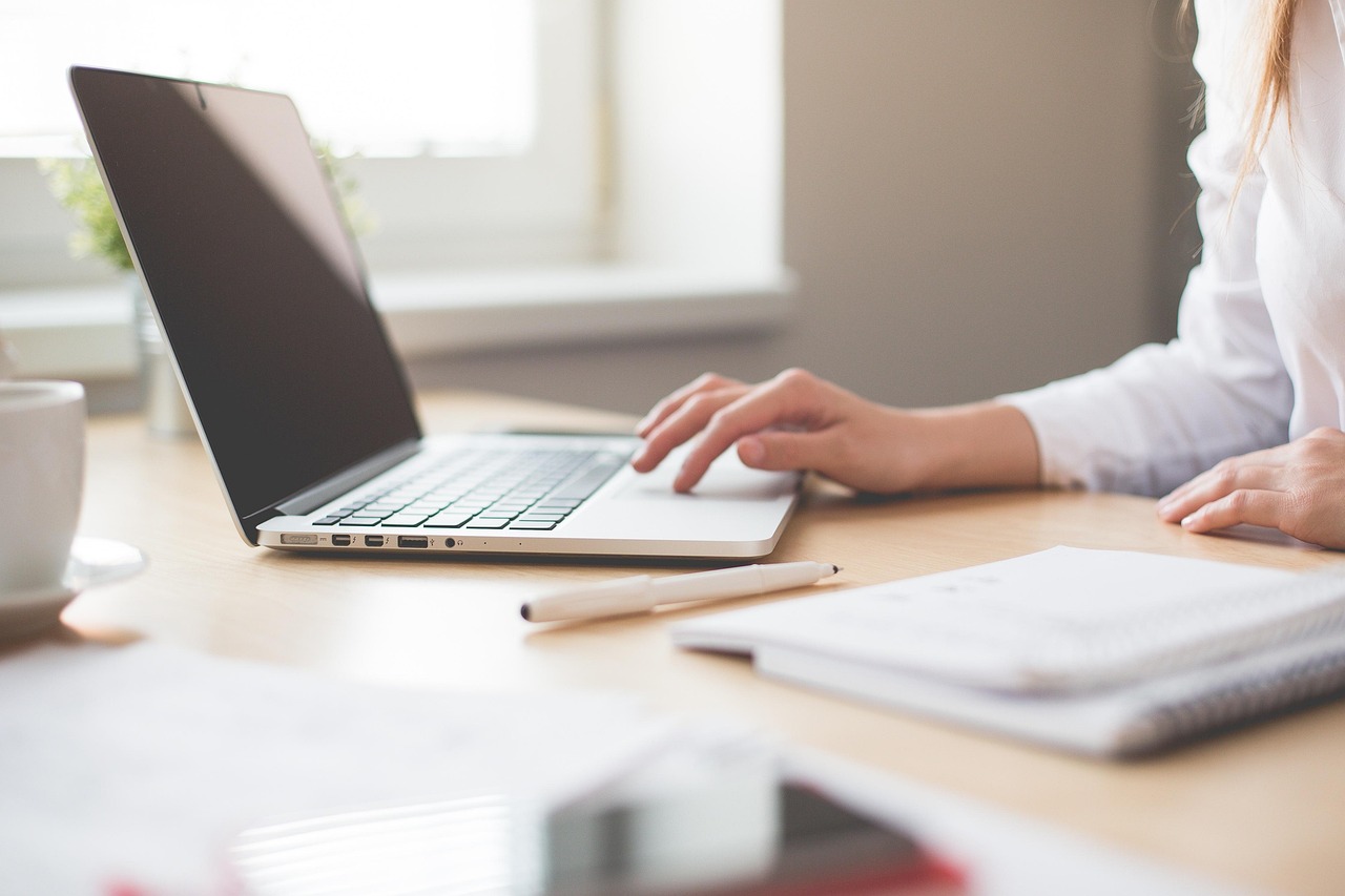 Bookkeeper working on a laptop in a bright office